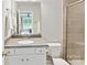 Bathroom with a large mirror, white vanity, and a tiled shower at 129 Overlook Ridge Ln, Davidson, NC 28036