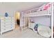 Bedroom with a fun loft bed with white dresser and a peek into the bathroom at 129 Overlook Ridge Ln, Davidson, NC 28036