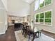 View of the dining room with tall ceilings and windows bringing light to kitchen area at 129 Overlook Ridge Ln, Davidson, NC 28036