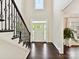 Bright foyer featuring hardwood floors, staircase, and a view of the front door at 129 Overlook Ridge Ln, Davidson, NC 28036