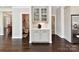 A butler's pantry is seen in a home hallway with cabinet storage for coffee and drinks at 129 Overlook Ridge Ln, Davidson, NC 28036