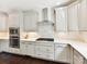 Updated kitchen features stainless steel appliances, gas cooktop, white cabinets, and modern backsplash at 129 Overlook Ridge Ln, Davidson, NC 28036