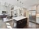 Open concept kitchen features a large island, stainless steel appliances, and seamless flow to dining at 129 Overlook Ridge Ln, Davidson, NC 28036