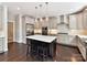 Bright kitchen features gray cabinetry, stainless appliances, large island with seating, and pendant lighting at 129 Overlook Ridge Ln, Davidson, NC 28036