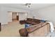 Spacious living room featuring a brown sofa, plush carpet, and ample lighting at 129 Overlook Ridge Ln, Davidson, NC 28036