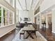 Open-concept living room with coffered ceilings, large windows, and seamless flow to dining area at 129 Overlook Ridge Ln, Davidson, NC 28036