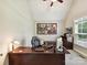 Well-lit office with a large desk, comfortable chair, and a window view at 129 Overlook Ridge Ln, Davidson, NC 28036