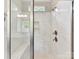 Modern bathroom shower with marble tiling, bench, and dual shower heads at 129 Overlook Ridge Ln, Davidson, NC 28036