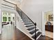 Grand staircase with decorative black railings leading to the upper level of the home at 129 Overlook Ridge Ln, Davidson, NC 28036