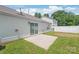 Backyard with sliding glass doors, concrete patio, grass, and a white fence at 13408 Golden Apple Ct, Charlotte, NC 28215