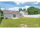 Backyard featuring sliding glass doors, concrete patio, grass, and a white fence at 13408 Golden Apple Ct, Charlotte, NC 28215