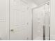 Clean bathroom featuring an enclosed shower, a neutral color scheme, and a white door at 13408 Golden Apple Ct, Charlotte, NC 28215