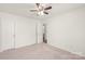 Bedroom with a door, neutral carpet, and a ceiling fan at 13408 Golden Apple Ct, Charlotte, NC 28215