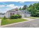 Charming two-story home with well-manicured lawn, attached garage, and beautiful landscaping at 13408 Golden Apple Ct, Charlotte, NC 28215