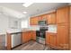 Open-concept kitchen featuring wood cabinets, stainless steel appliances, and white countertops at 13408 Golden Apple Ct, Charlotte, NC 28215