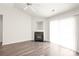 Bright living area with a fireplace, sliding glass doors, and modern vinyl wood flooring at 13408 Golden Apple Ct, Charlotte, NC 28215