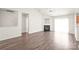 Open-concept living area with a fireplace, abundant natural light, and vinyl wood floors at 13408 Golden Apple Ct, Charlotte, NC 28215
