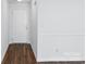 Bright living room featuring fresh white walls and vinyl wood flooring at 13408 Golden Apple Ct, Charlotte, NC 28215