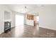 Open living space with a fireplace, ceiling fan, and access to the kitchen area at 13408 Golden Apple Ct, Charlotte, NC 28215