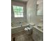 Bathroom with white tile and fixtures with an open window for natural light at 140 Porter Rd, Statesville, NC 28625