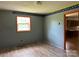 Bedroom with wood-look flooring, gray walls and contrasting wallpaper border at 140 Porter Rd, Statesville, NC 28625
