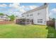 Lush backyard with a white house, screened porch, and green lawn at 14104 Kendrick Cross Rd, Charlotte, NC 28273