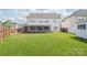 A spacious backyard features a green lawn and a screened porch, offering a great outdoor space at 14104 Kendrick Cross Rd, Charlotte, NC 28273