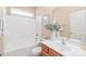 Cozy bathroom features a combined shower and tub, wood vanity, and ample natural light at 14104 Kendrick Cross Rd, Charlotte, NC 28273