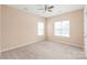 Inviting bedroom filled with natural light, neutral walls, plush carpeting, and a fan at 14104 Kendrick Cross Rd, Charlotte, NC 28273
