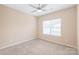 Simple bedroom with carpet, ceiling fan, a window bringing in natural light, and neutral wall color at 14104 Kendrick Cross Rd, Charlotte, NC 28273