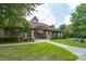 Inviting clubhouse entrance with stone facade, arched entryway, and manicured landscaping, perfect for community gatherings at 14104 Kendrick Cross Rd, Charlotte, NC 28273