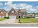 Traditional brick home featuring a well-kept lawn, two car garage, and neighborhood setting at 14104 Kendrick Cross Rd, Charlotte, NC 28273