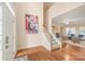 Inviting foyer featuring hardwood floors, a staircase, and views into the living room at 14104 Kendrick Cross Rd, Charlotte, NC 28273