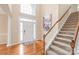 Bright foyer with hardwood floors, staircase, and elegant decor at 14104 Kendrick Cross Rd, Charlotte, NC 28273