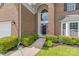 Inviting brick home entrance with arched window and manicured landscaping at 14104 Kendrick Cross Rd, Charlotte, NC 28273