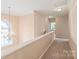 Hallway with chandelier with neutral paint and carpet at 14104 Kendrick Cross Rd, Charlotte, NC 28273