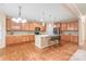 Spacious kitchen features wood cabinets, center island with seating, and stainless steel appliances at 14104 Kendrick Cross Rd, Charlotte, NC 28273