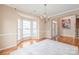 Formal living room with bay windows and an elegant chandelier at 14104 Kendrick Cross Rd, Charlotte, NC 28273