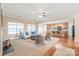 Open-concept living area with a fireplace, hardwood floors, and seamless kitchen access at 14104 Kendrick Cross Rd, Charlotte, NC 28273