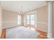 Open living area with wainscoting, bay windows, and natural light at 14104 Kendrick Cross Rd, Charlotte, NC 28273