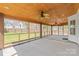 Covered and screened back porch with an stained wood ceiling overlooking the green backyard at 14104 Kendrick Cross Rd, Charlotte, NC 28273