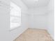Spacious walk-in closet offers ample storage with shelving and great natural light at 14104 Kendrick Cross Rd, Charlotte, NC 28273