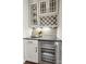 Modern bar area with wine refrigerator, countertop, and custom cabinets at 14210 Kershaw Cir # 20, Huntersville, NC 28078