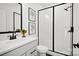 Modern bathroom features a white vanity, minimalist artwork, and a glass-enclosed shower with white subway tile at 14210 Kershaw Cir # 20, Huntersville, NC 28078