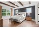 Beautiful bedroom with hardwood floors, beamed ceiling, and luxurious king-size bed at 14210 Kershaw Cir # 20, Huntersville, NC 28078