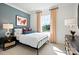 Charming bedroom with a metal bed frame, blue accent wall, and bright natural light at 14210 Kershaw Cir # 20, Huntersville, NC 28078