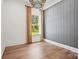 Minimalist bedroom with hardwood floors, gray accent wall, and a bright window view at 14210 Kershaw Cir # 20, Huntersville, NC 28078