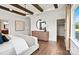 Bedroom featuring light-colored floors, wood dresser and a large circular mirror at 14210 Kershaw Cir # 20, Huntersville, NC 28078
