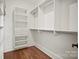 Bright walk-in closet featuring built-in shelving and hanging rods for optimal organization at 14210 Kershaw Cir # 20, Huntersville, NC 28078