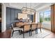 Elegant dining room with modern chandelier, hardwood floors, and large window at 14210 Kershaw Cir # 20, Huntersville, NC 28078